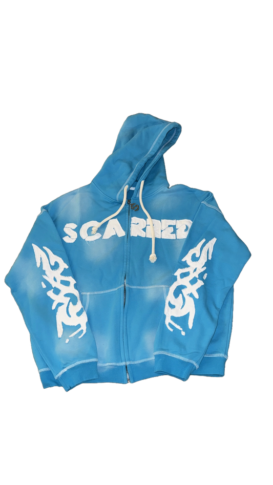 “Scarred” blue sweater